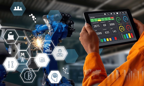 Industrial worker holding tablet with manufacturing dashboard and automation icons overlay