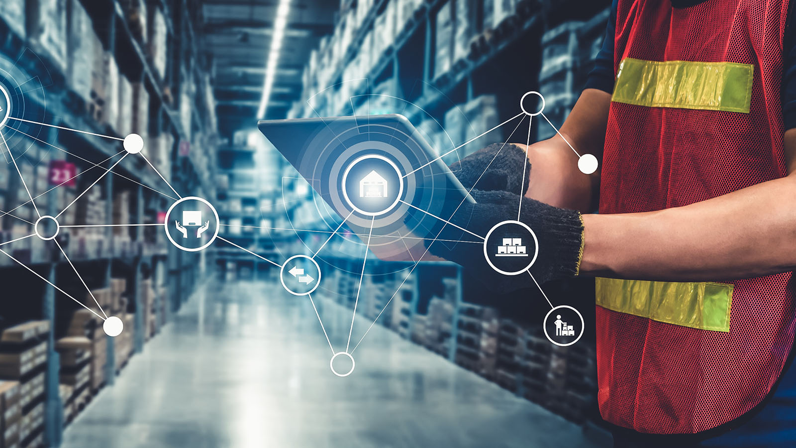 Warehouse worker using tablet with connected logistics automation icons in warehouse